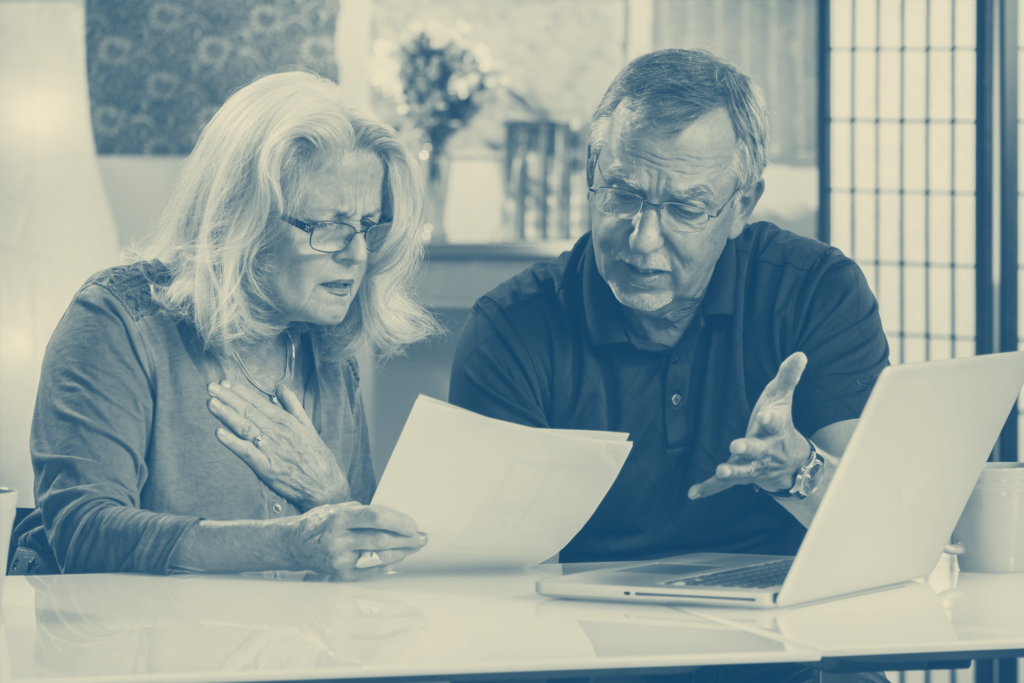 Concerned older couple looking at paperwork